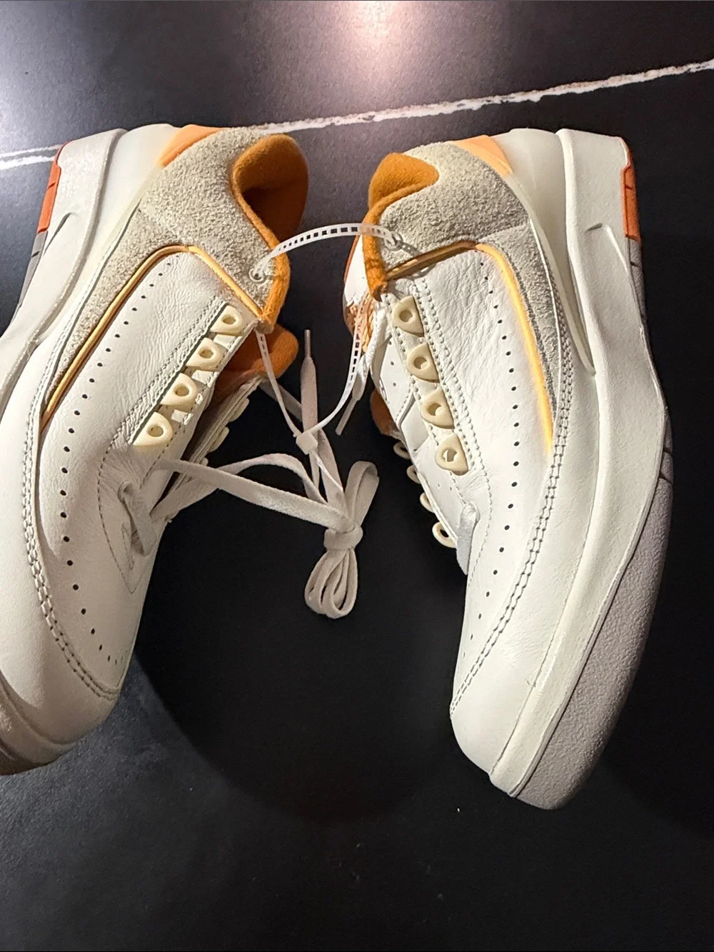 Jordan White and Orange Low-Top Sneakers with Gold Logo Accent